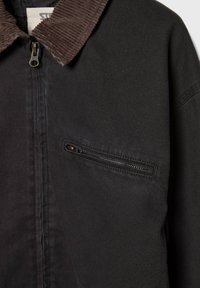 Black jacket with a corduroy collar, featuring a zipper closure and a small zippered chest pocket. Textured fabric with a plain design.