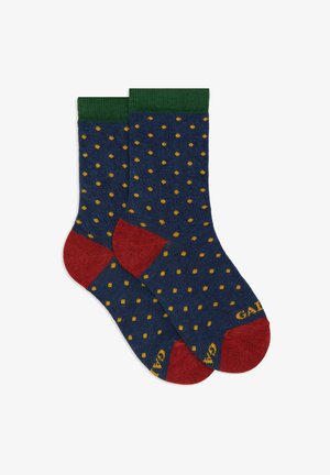 Calzini blu marina con pois gialli, polsini a coste verdi e accenti rossi sulla punta e sul tallone. Realizzati in tessuto morbido e testurizzato. Nome del marchio visibile.