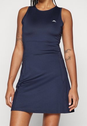 Robe de sport marine à design sans manches, col rond, poches latérales zippées et détails discrets du logo. Tissu lisse et extensible.