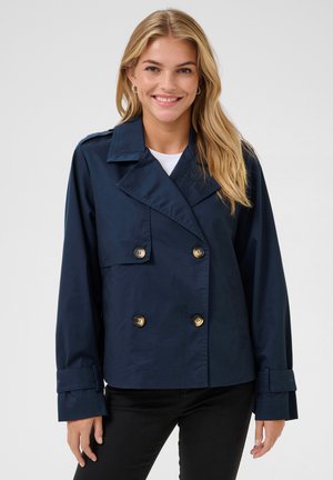 Navy blue double-breasted trench coat with large gold buttons, wide collar, and cuffed sleeves. Smooth texture and fitted design.