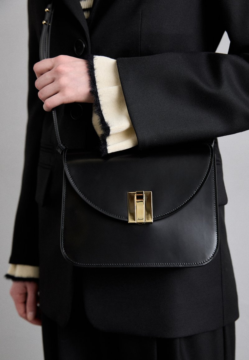 Bally OLLAM FLAP CROSSBODY - Cross body bag - black/yellow gold