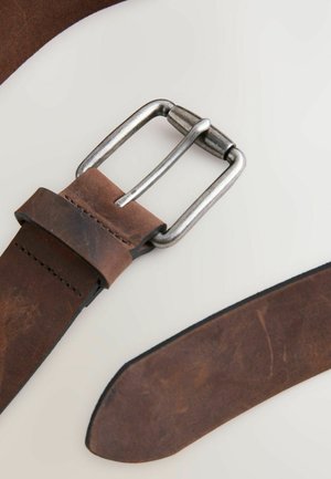 Brown leather belt featuring a silver metal buckle, smooth texture, and a neatly stitched edge. The end of the belt is tapered.