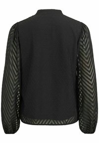 Blouse noire à manches longues avec un motif chevron texturé. Les manches transparentes présentent un design géométrique. Col haut et coupe décontractée.
