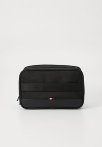 Black rectangular cosmetic bag made of durable fabric. Features a smooth front panel, logo, and a colored accent at the bottom. Zipper closure.