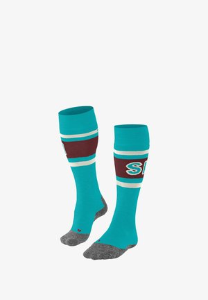 Kousen tot kniehoogte in turquoise met bruine en witte strepen, voorzien van een logo. Grijze versterkte teen en hiel. Zacht, rekbaar gebreid materiaal.