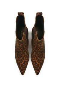 Leopard print ankle boots made of suede with pointed toes, brown and black pattern, elastic sides, and pull tabs at the back.