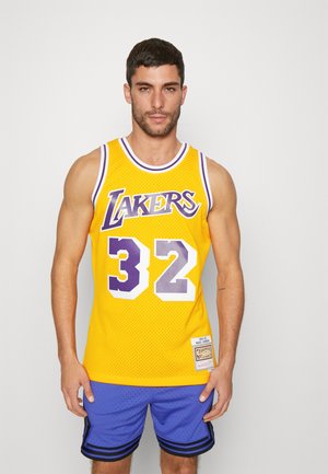 Yellow mesh basketball jersey with purple accents, featuring "Lakers" text and number "32" in white. Paired with blue shorts.