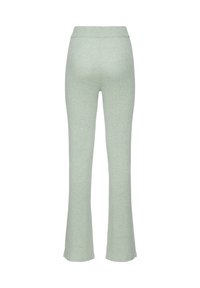 Ribbed flared pants in light green, featuring an elastic waistband, soft texture, and a fitted silhouette that flares from the knee down.
