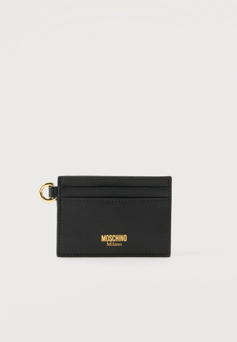 Μαύρο δερμάτινο θήκη καρτών Moschino με χρυσό λογότυπο και ένα μικρό χρυσό κρίκο στην αριστερή πλευρά για συνδέσεις.
