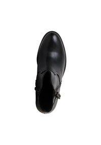 Botte basse en cuir noir avec bout arrondi, fermeture éclair latérale et coutures décoratives, vue de dessus sur fond blanc.