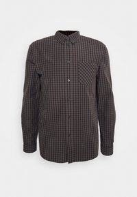 Chemise à carreaux marron et noir à manches longues avec boutons, poche poitrine et col, présentée sur fond blanc.
