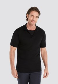 Black polo shirt made of smooth fabric, featuring a classic collar, short sleeves, and a fitted design. No visible patterns or accents.