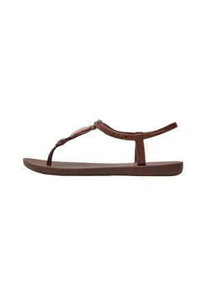 Brun flad sandal med en tynd tårem, dekorativt midterstykke og justerbar ankelrem med mærkenavn på siden.