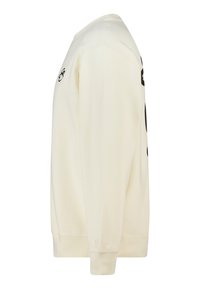 Gebroken-witte sweatshirt met lange mouwen, geribbelde manchetten en zoom, voorzien van een grote zwarte afbeelding aan de voorkant en een gladde textuur.