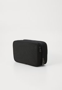 Black rectangular toiletry bag made of textured fabric featuring dual zippers and a slim profile suitable for travel or storage.