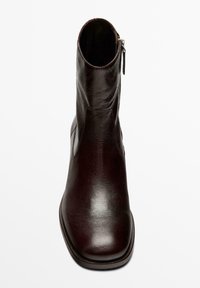 Bordelové kotníkové boty z hladké kůže, se zapínáním na boční zip a kulatou špičkou. Plochý podpatek a minimalistický design.