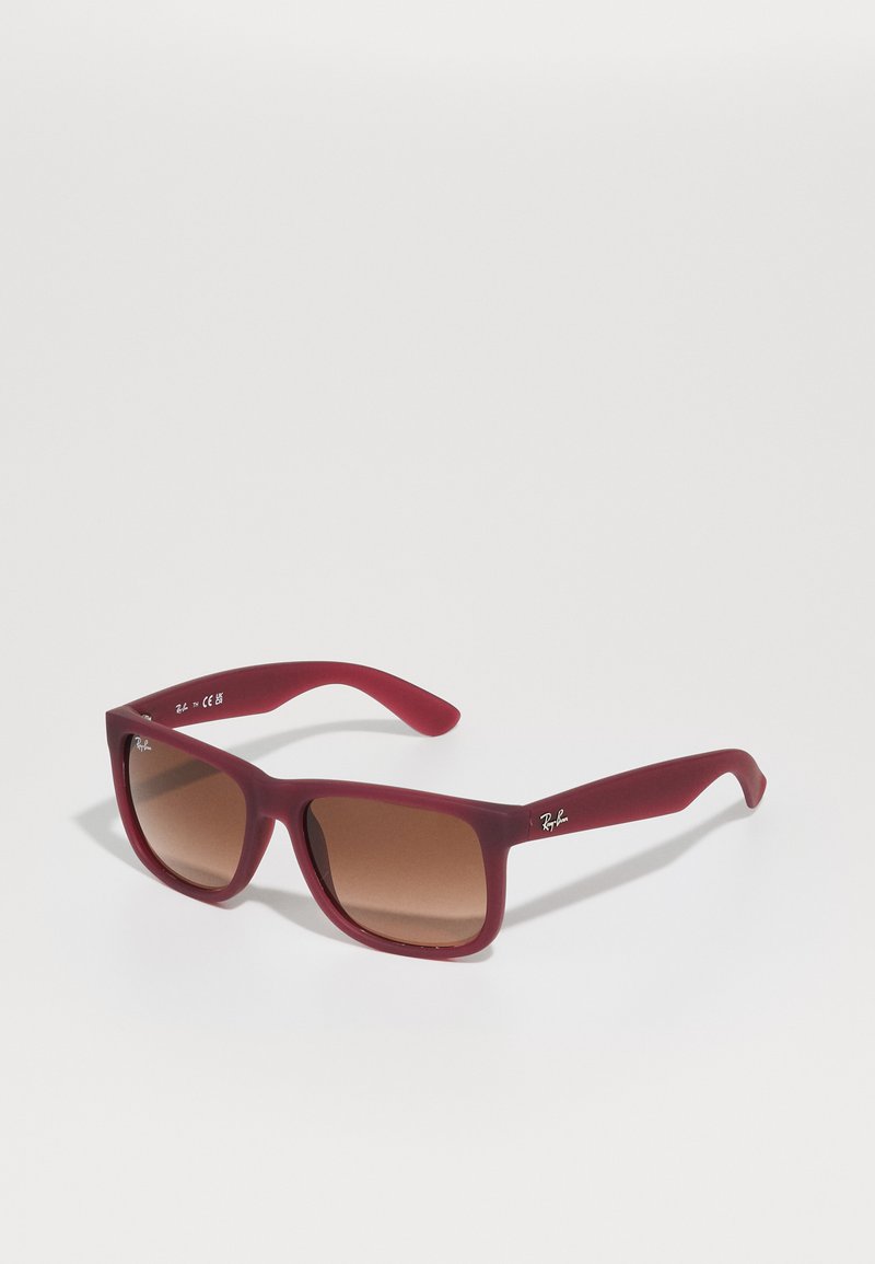 Red acetate sunglasses with a square frame, gradient brown lenses, and a matte finish. Features logo on the temple and rounded tips.