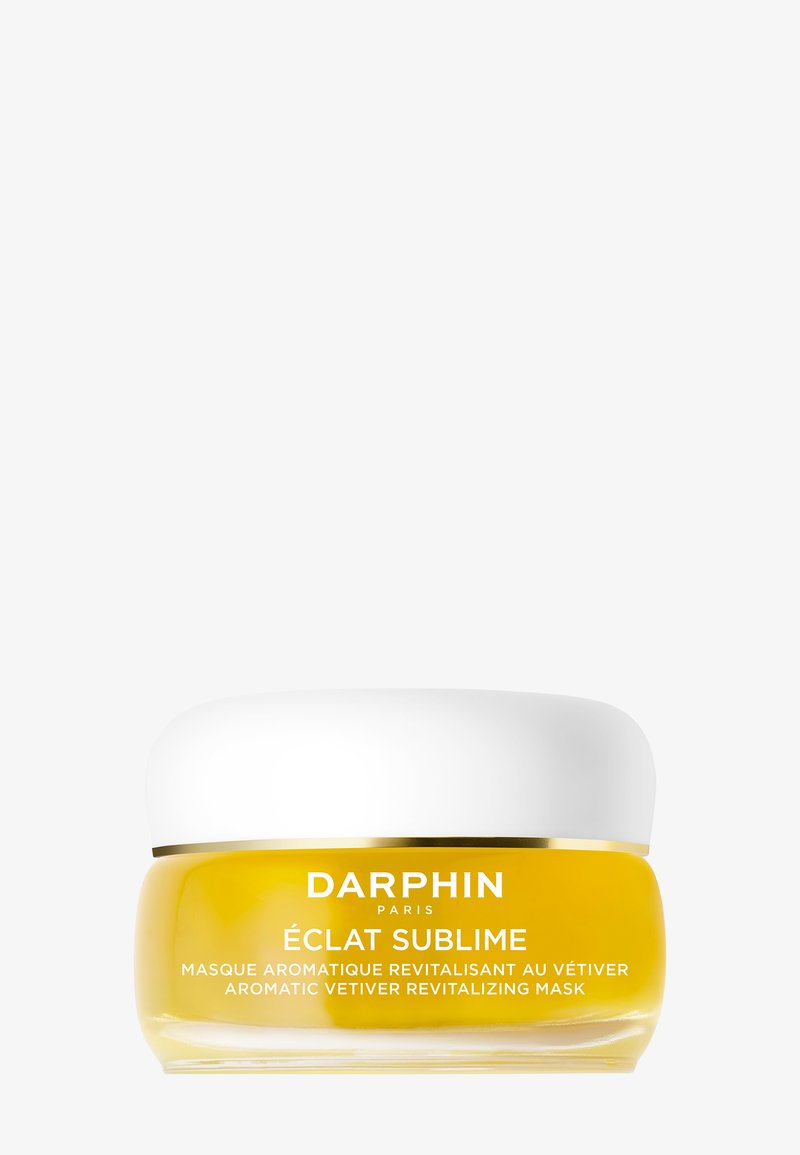 Darphin Eclat Sublime Aromatic Vetiver Uppiggande Mask i en klar glasburk med ett vitt lock, med en livlig gul krämig konsistens.