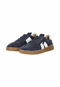 Navy blue suede sneakers with white side panels, textured lace-up closure, and a rubber gum sole. Includes a side zip detail.