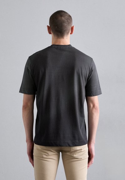 Short-sleeve black t-shirt with a subtle dotted pattern, made of lightweight fabric, featuring a round neckline and relaxed fit.