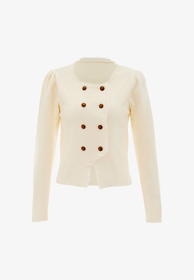 Krém színű kardigán, hosszú ujjal, amely rántott szélekkel rendelkezik és hét barna, kerek gomb található az elülső részén. Texturált kötött anyag.