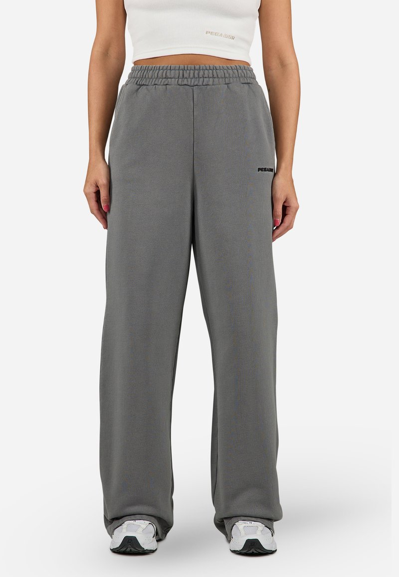 Gray wide-leg sweatpants with an elastic waistband and side pockets, featuring a small black logo on the left leg. Soft fabric texture.