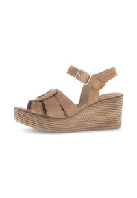 Brown suede wedge sandals with a braided texture, open toe, and adjustable ankle strap featuring a buckle. Notable round accent on the front.