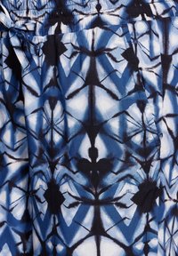 Blue and white patterned fabric with abstract shapes. Soft texture, elastic waistband, and a tied drawstring detail.