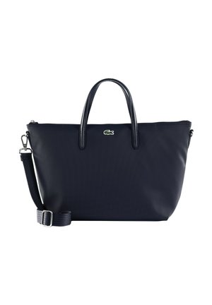 Sac fourre-tout noir Lacoste avec double poignée, bandoulière détachable et ajustable, et logo crocodile vert au centre avant.
