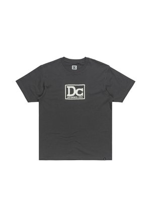 Camiseta de algodón gris oscuro con un destacado logo blanco "DC" y el texto "DC SHOES 1994" dentro de un marco rectangular. Mangas cortas, cuello redondo.