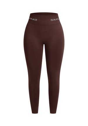 Bruine leggings met een brede elastische tailleband met witte "SMIL" tekst. Gladde stof, taps toelopend ontwerp, geen zichtbare naden of patronen.