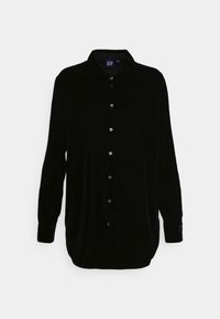 Camicia a maniche lunghe in velluto nero con bottoni sul davanti, colletto a punta e maniche con polsini; texture liscia e vestibilità comoda.