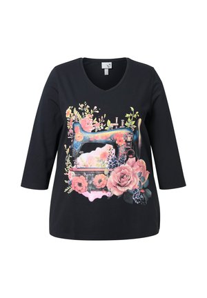 Black long-sleeve t-shirt with a colorful floral print featuring a vintage sewing machine design, round neckline, and soft fabric texture.