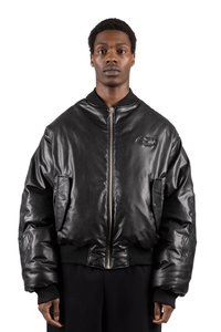 Black leather bomber jacket with a front zipper, ribbed cuffs and hem, and side pockets. Features a subtle branded emblem on the chest.