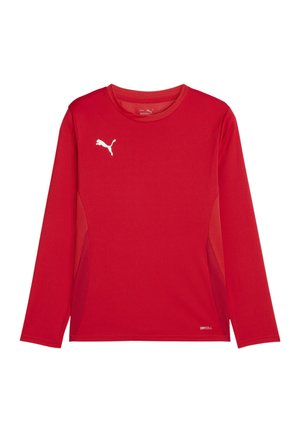 Chemise de sport à manches longues rouge en tissu évacuant l'humidité, avec panneaux latéraux en maille et logo blanc sur la poitrine. Design léger et respirant.