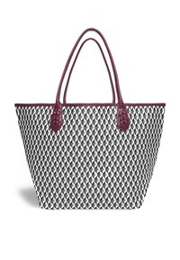 Patterned tote bag featuring a geometric black and white design with burgundy synthetic leather handles and trim. Textured fabric.