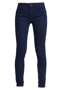 Jeans skinny azules marinos hechos de denim, con cierre de cremallera, botón, presillas para cinturón y dos bolsillos frontales con costuras mínimas.