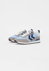 Blue and gray athletic sneakers featuring a mix of suede and mesh materials, white laces, and a navy chevron design. Rubber sole.
