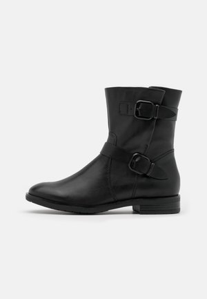 Botte mi-mollet noire en cuir avec deux sangles réglables et boucles, talon bas et bout arrondi.