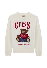 Pull en tricot blanc cassé arborant un graphisme d'ours en rouge et marron, avec le texte "GUESS" au-dessus et "LOS ANGELES EST. 1981" en dessous.