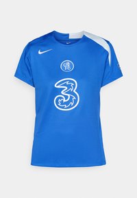 Sininen Nike-jalkapallopaita, jossa on lyhyet hihat, pyöreä kaula-aukko, seuran logo rinnassa ja suuri valkoinen numero "3".
