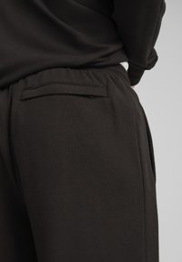 Puma RELAXED TRACK PANTS - Tepláky - black black