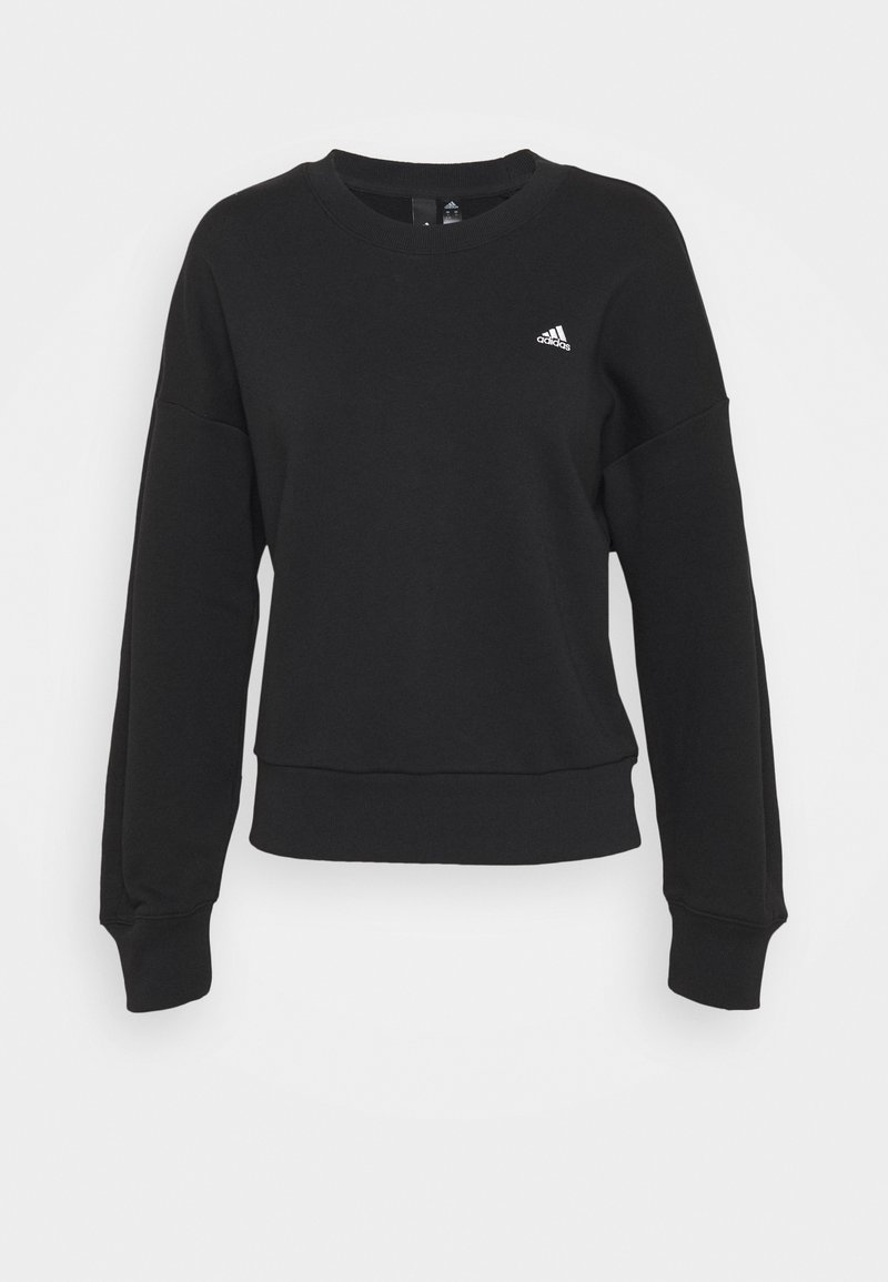 Sweatshirt Adidas noir à manches longues, col ras du cou, poignets et ourlet côtelés, avec petit logo Adidas blanc sur le côté gauche de la poitrine.