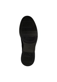 Suela de zapato de goma negra con superficie texturada y patrones circulares distintivos. Presenta surcos horizontales y bordes reforzados.