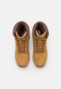 Stivali in pelle marrone a metà altezza con un colletto imbottito, lacci color testa di moro e una suola in gomma bianca con dettagli testurizzati.