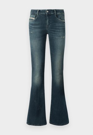 Jeans a campana blu scuro con sfumature leggere e whiskering, chiusura con bottone e cerniera frontale, tasche anteriori e posteriori.