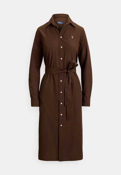 Long-sleeve brown shirt dress with buttons down the front, a fabric belt tied at the waist, and a small yellow embroidered logo on the chest.