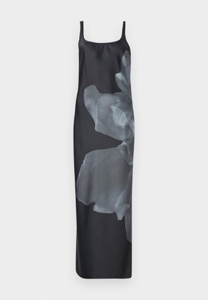 Satin slip dress in black with a large, translucent floral print on one side. Features thin straps and a straight, flowy silhouette.