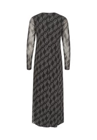 Dolga črna obleka s prosojnimi dolgimi rokavi, ki vsebuje ponavljajoč se bel grafični vzorec. Ohlapen kroj in dolžina do gležnjev.