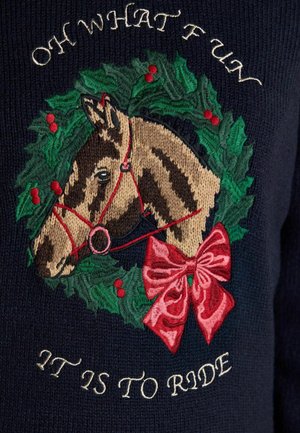Horse head with red bridle inside a green holly wreath with red berries and a large red bow, text above and below the design on dark fabric.